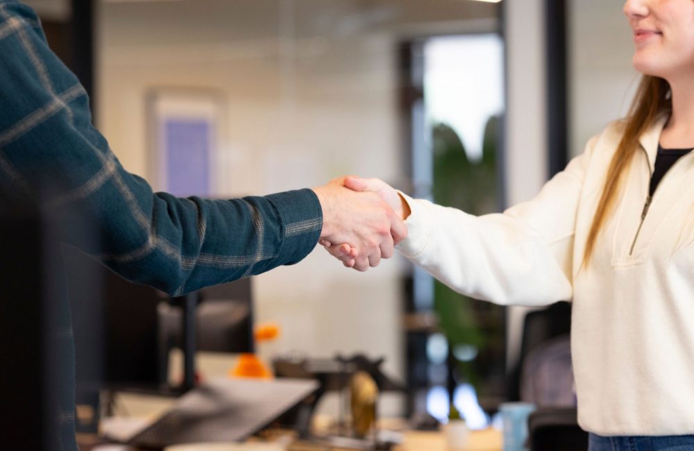 coworkers shaking hands at the office